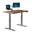 angle view of electric standing desk with comfort edge in walnut
